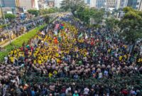 This aerial picture shows students protesting to demand a reduction in fuel prices and the dissolution of the free meal program, which they consider to be a hotbed of corruption, in Jakarta on June 12, 2026. (Photo by BAY ISMOYO / AFP)